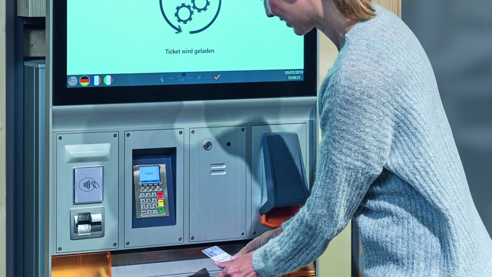 lady getting a ticket from axess machine